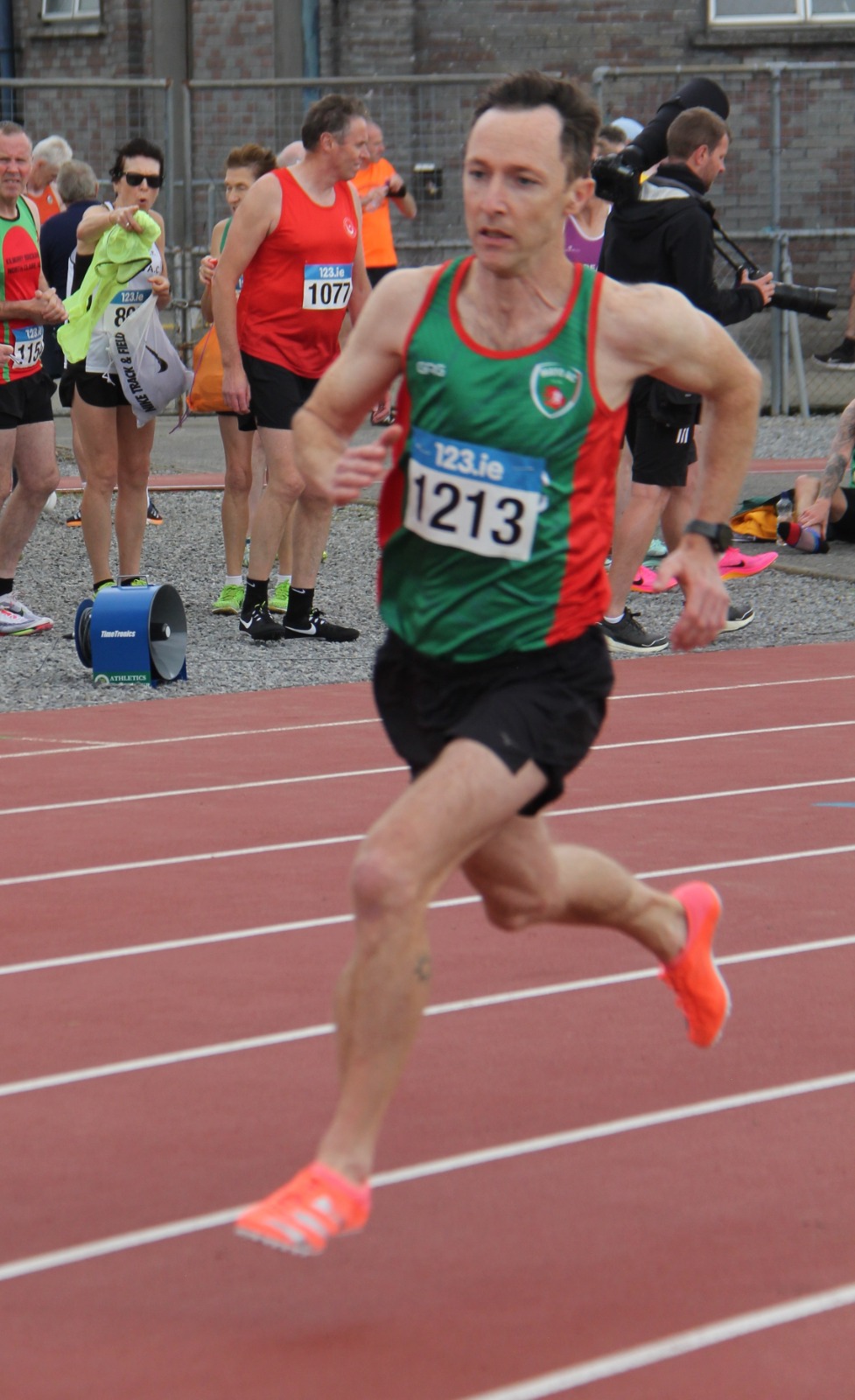 A photo of Mike racing on a running track